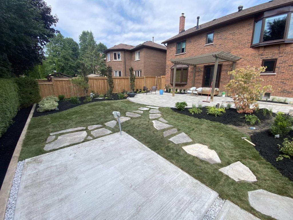 flagstones laid in grass leading to a paved patio
