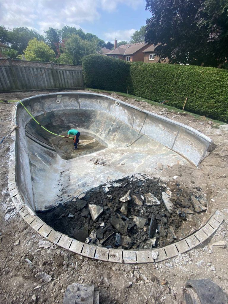 the last dregs of water being pumped out of a swimming pool
