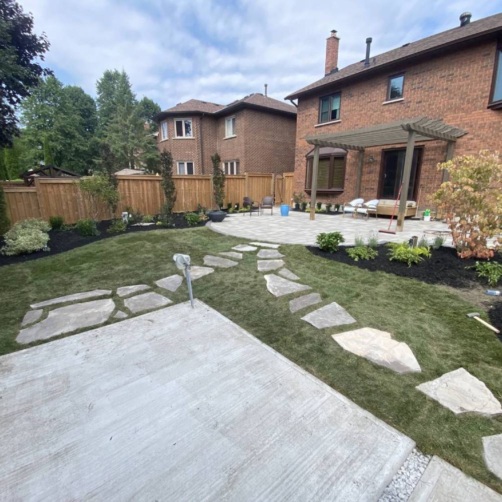 flagstones laid in grass leading to a paved patio