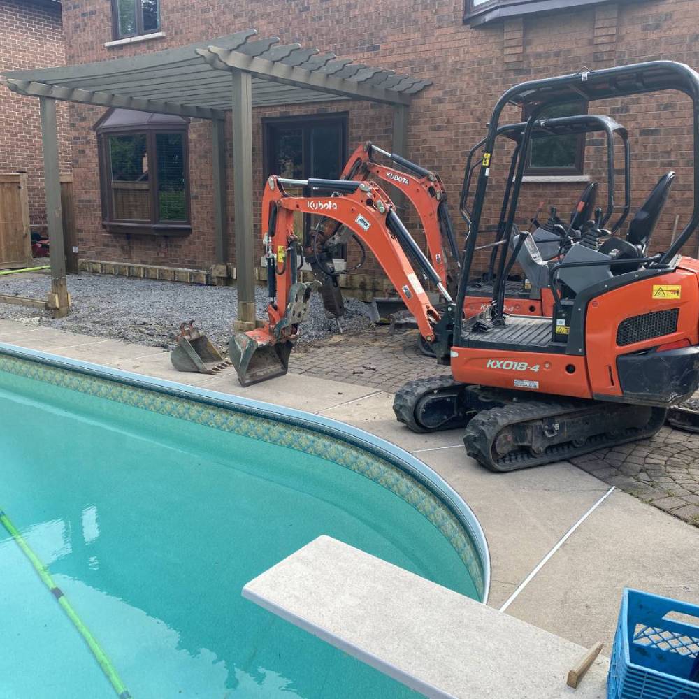a digger next to a swimming pool