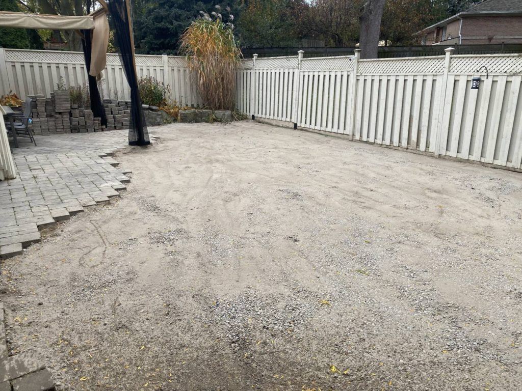 backyard transformation in progress: old patio stones removed