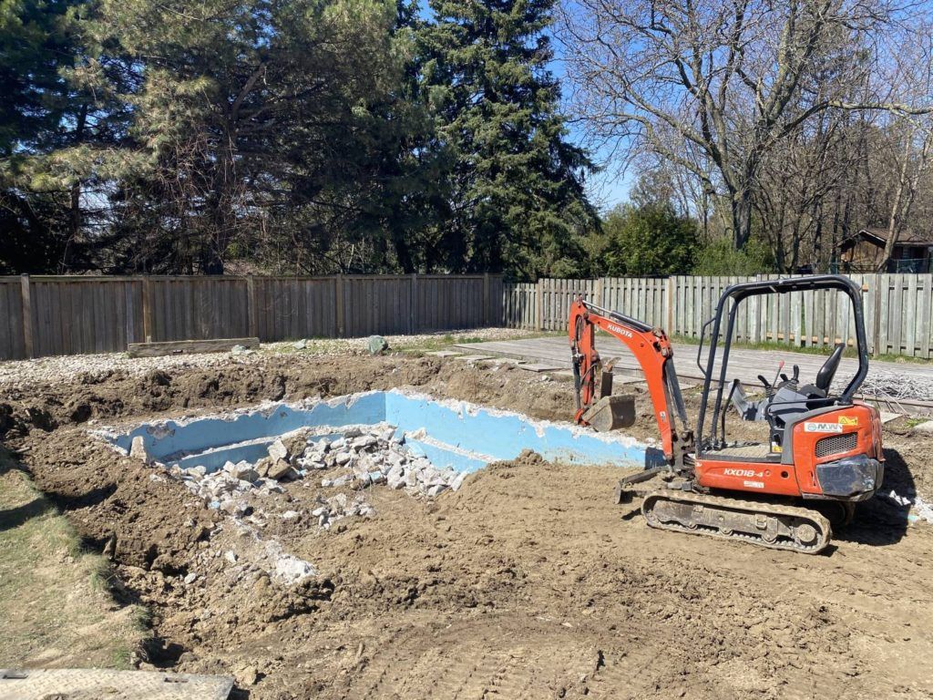 a partially removed pool being filled with sand
