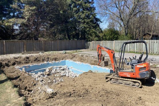 a partially removed pool being filled with sand