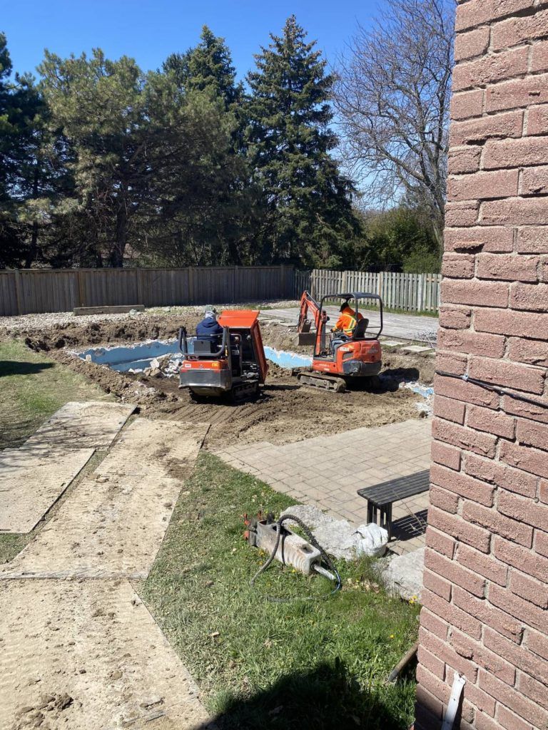 two heavy machines in the process of breaking up a pool