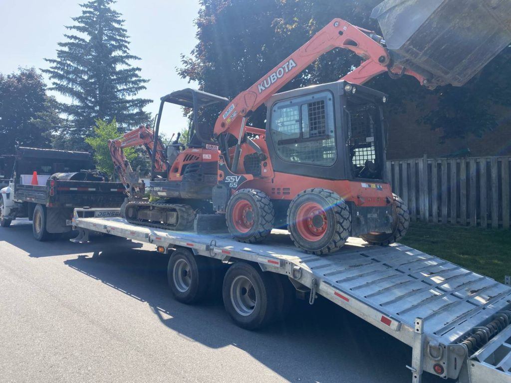 kubota machinery on a flatbed trailer