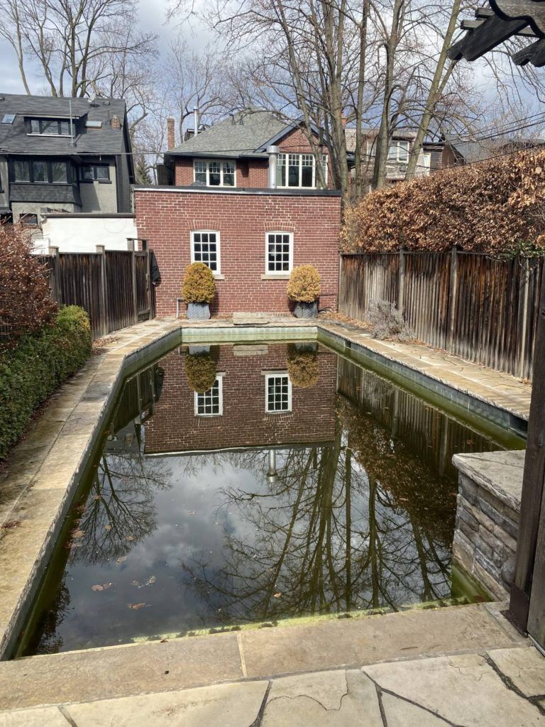 a swimming pool reflecting its surroundings