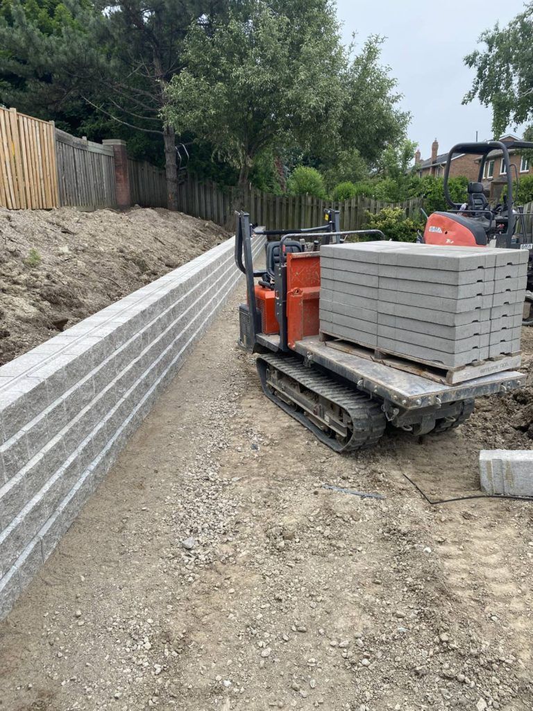 a kubota tractor carrying concrete slabs