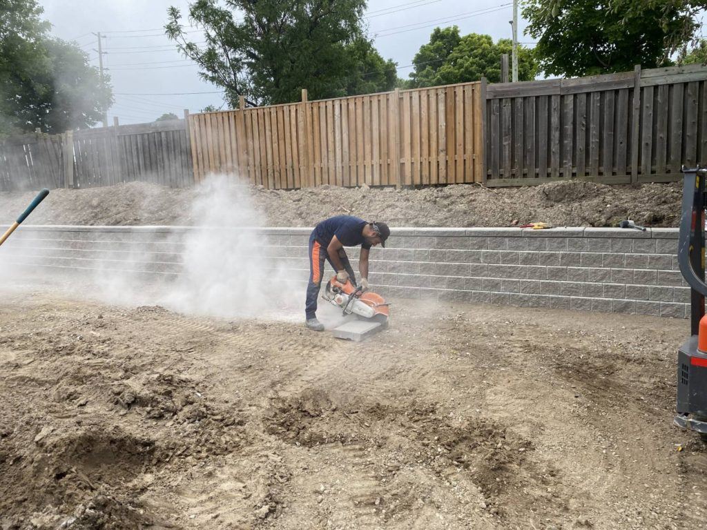 a man cutting a thick tile with a motorized cutter