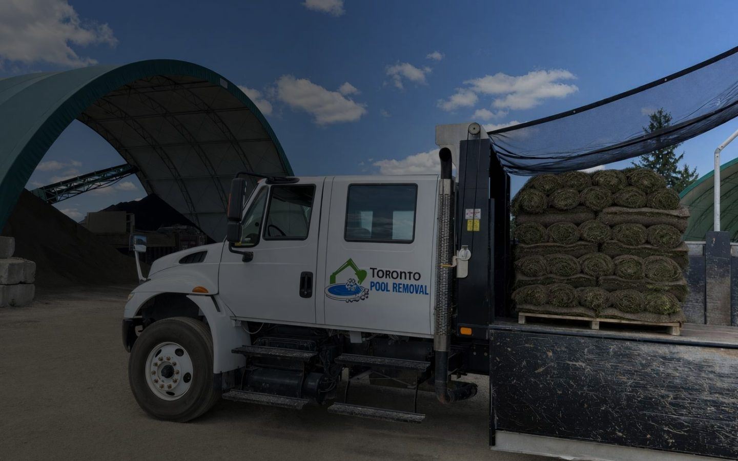 a truck carrying rolled up turf